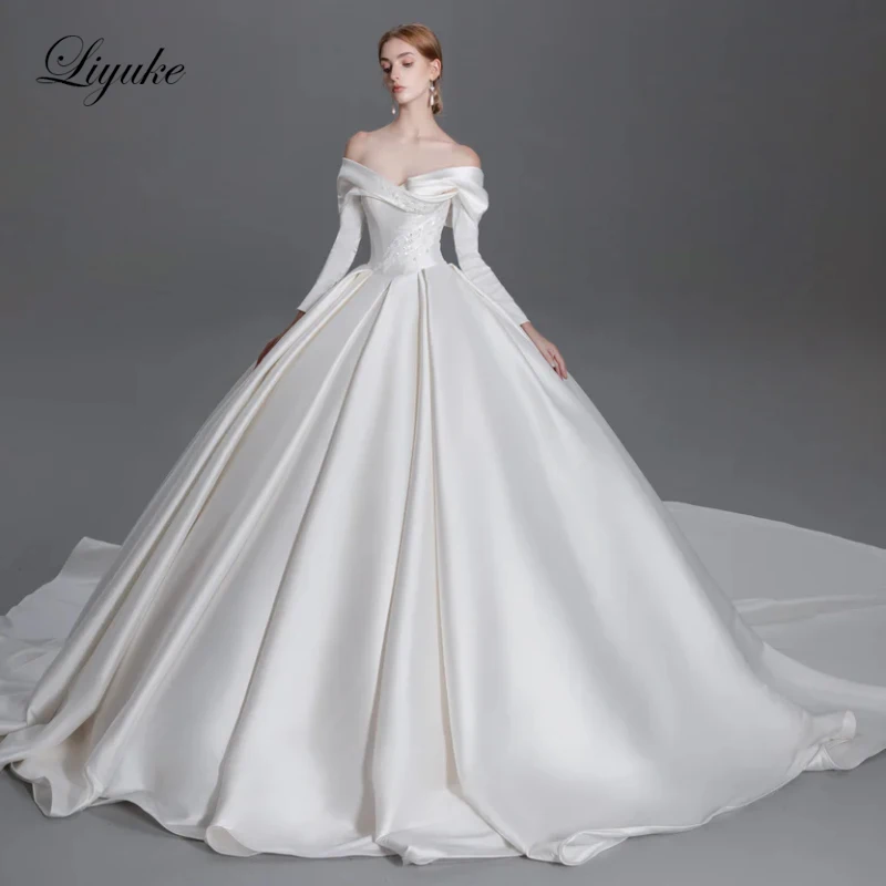 

Свадебное платье Liyuke на заказ: роскошное атласное плиссированное платье с V-образным вырезом, открытыми плечами, длинными рукавами, расшитое бисером и жемчугом