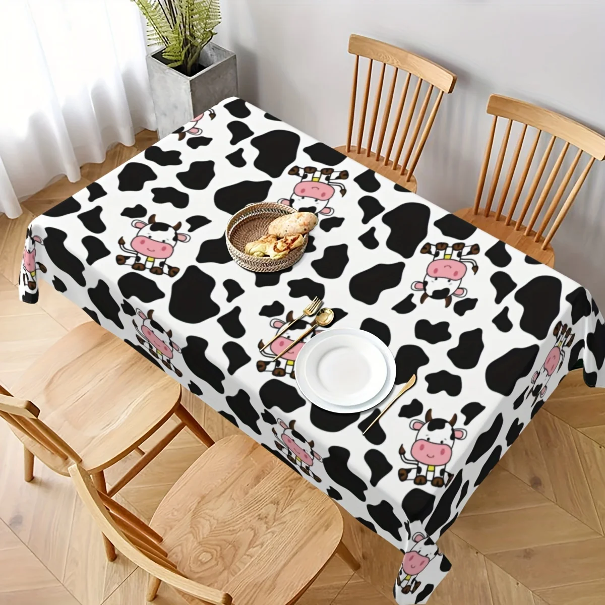 One-time use plastic rectangular table cover for animal-themed picnic party supplies at a dairy farm.PMJ