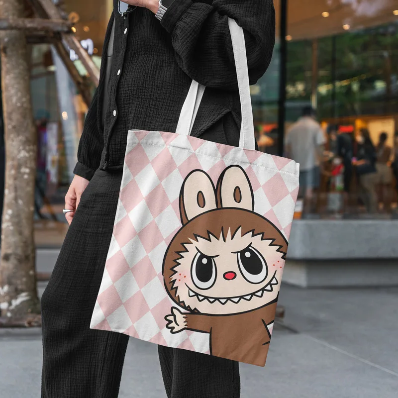 

The Monster Labubu Canvas Bag College Female Cute Cartoon Shopping HandBag Lisa Same Casual Student Anime Shoulder Bag FJ07A