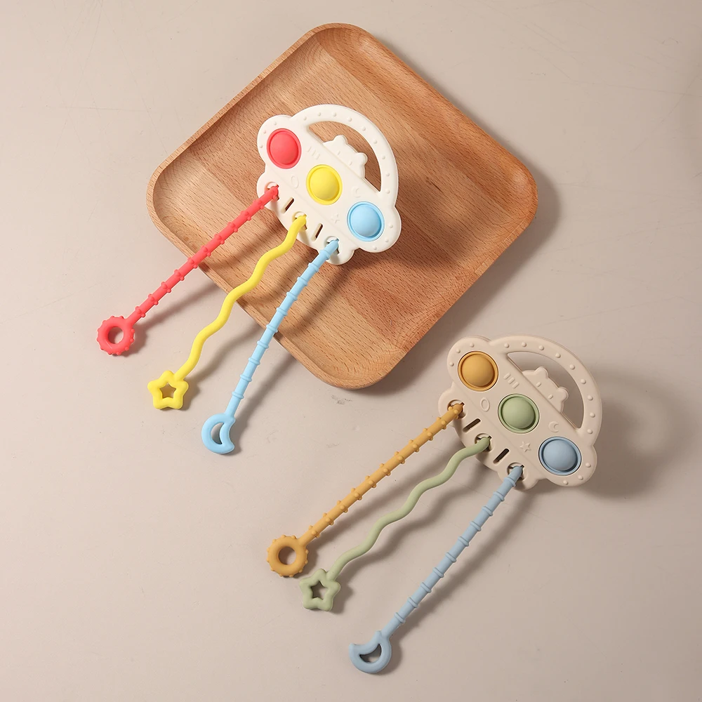 2025 New Infant Teething Toy with Press Buttons & Pull String – Soft Silicone Chew Toy Activity Gum Relief