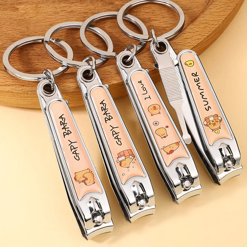 

Cartoon colorful film nail clipper keychain stainless steel nail clipper ear spoon students arc home nail clippers.