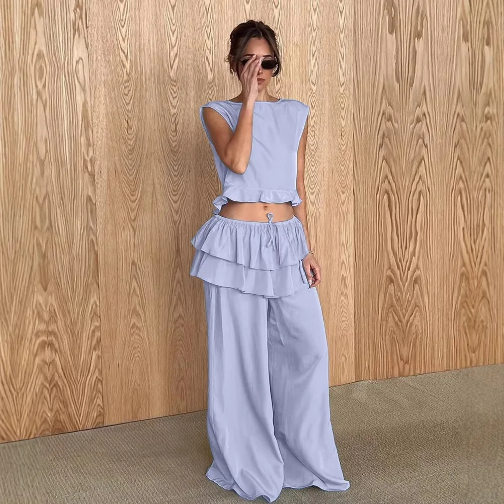 

Two-piece set: sleeveless ruffled cropped camisole top for women and long pants with a cake skirt hem panel