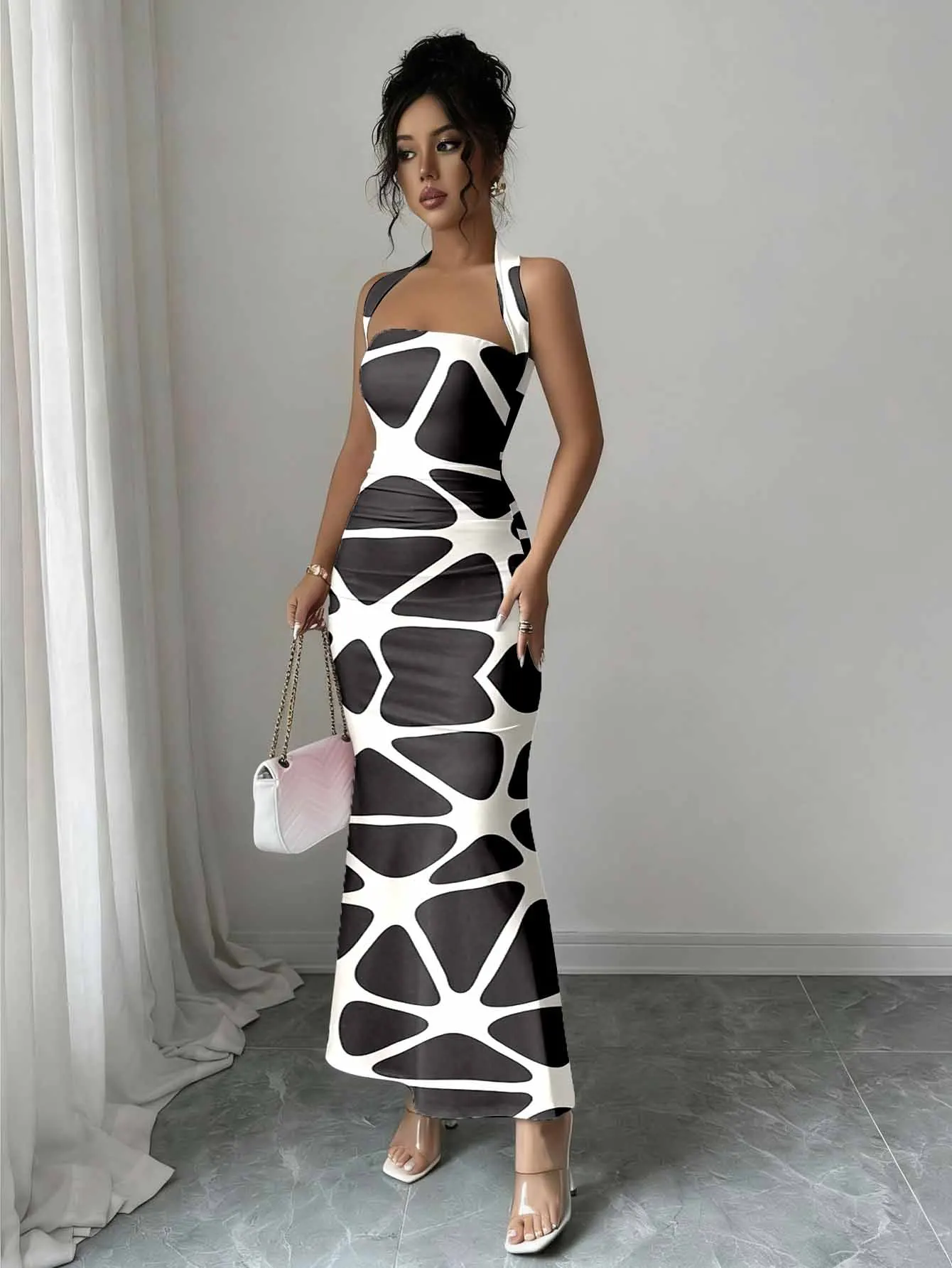 Tailored hip hugging fishtail dress with a hanging neck and sleeveless design that highlights feminine lines