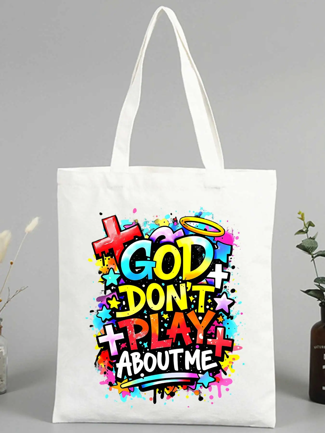 

Women's slogan-style canvas tote bag with colorful religious-inspired graphics, ideal for casual daily use