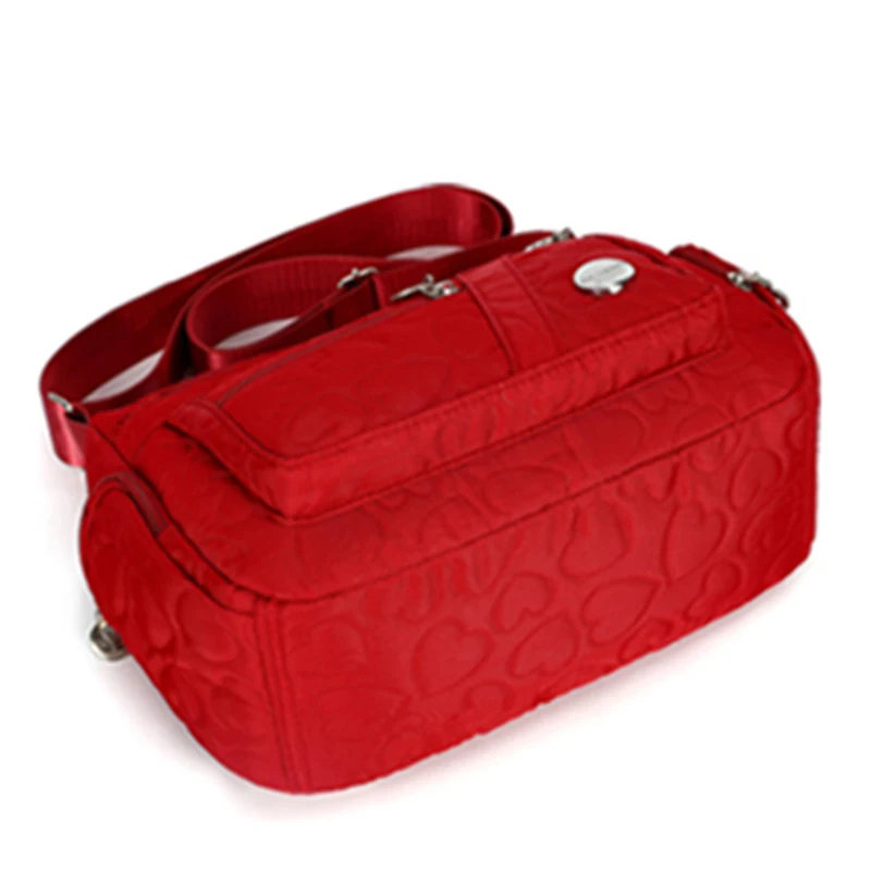 Schicke, verzierte Damen-Umhängetasche für den täglichen Pendelverkehr. Stilvolle, leichte, lässige Nylontasche mit Herzdetail und mehreren Taschen – Detail 3