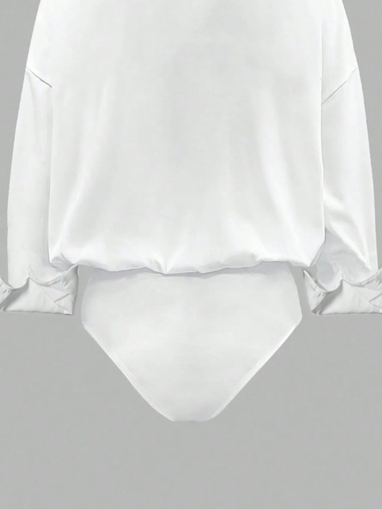 Oversized solid-colored jumpsuit with long sleeves in a versatile shirt style