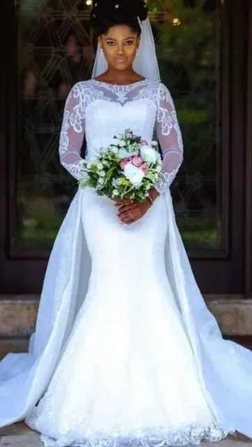 ชุดแต่งงานลูกไม้ทรงเมอร์เมดแบบสั่งตัด แขนยาว หางถอดได้ คอประดับเพชร สีขาว ชุดเจ้าสาวลูกไม้สไตล์แอฟริกันไนจีเรีย