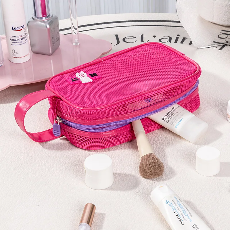 Handheld toiletry bag with mesh fabric for portable travel storage of skincare products. Beach-style fashionable makeup bag.
