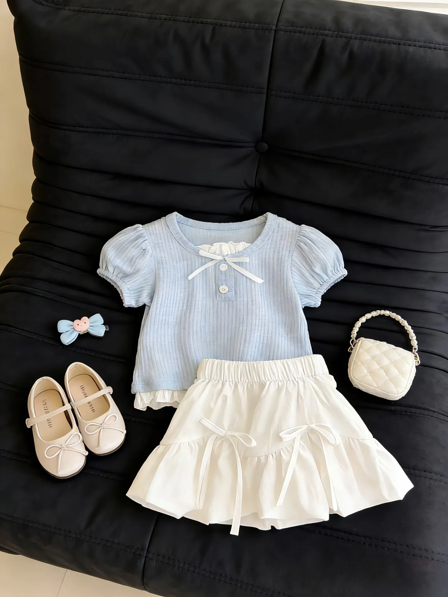 

Girls Summer Outfit 2026 New Sweet Bowknot Bubble Sleeve Short Sleeve Flower Bud Skirt Two Piece Set High Waist Pure Color Ts...