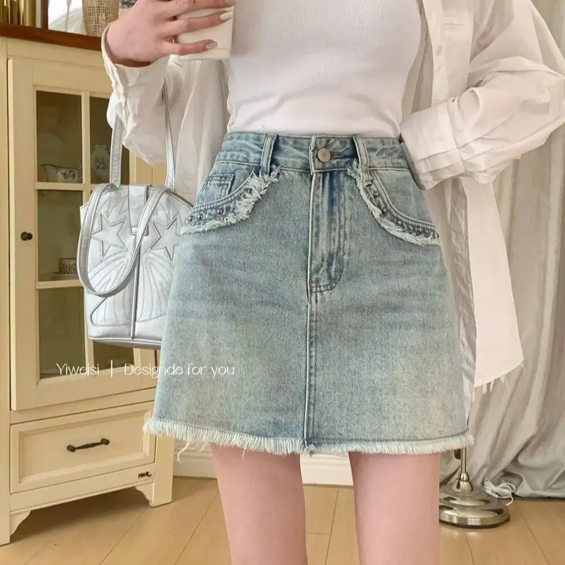 

Retro washed rivet raw edge denim skirt women 2024 new summer high waist a-line short skirt