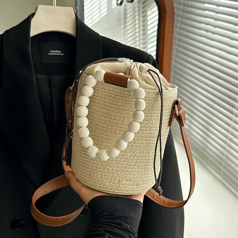 

Wooden Beads Straw Bucket Bags for Women 2025 New Summer Fashion Handbag Casual Beach Vacation Drawstring Shoulder Bag Woman