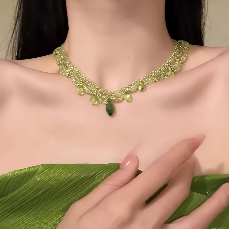 New green lace beaded necklace with multiple layers of layered dangler chains around the collarbone