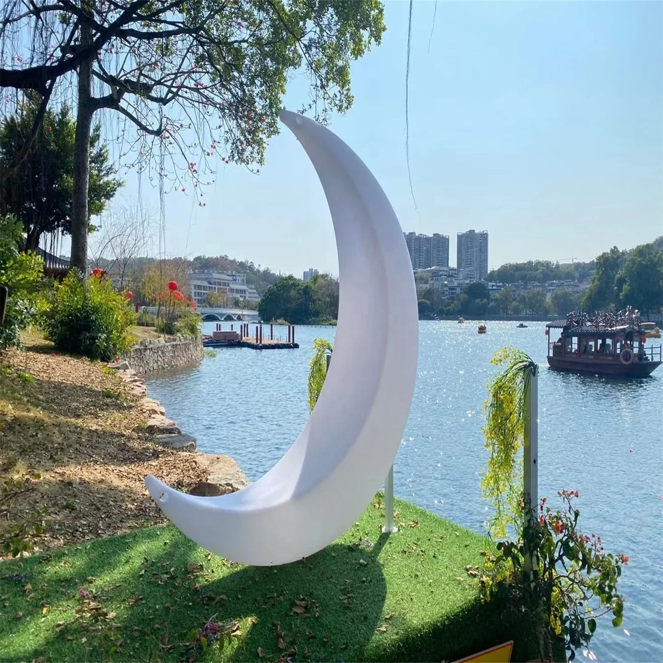 

Stylish luminous Crescent moon-shaped hanging chair used as a swing in the scenic leisure area