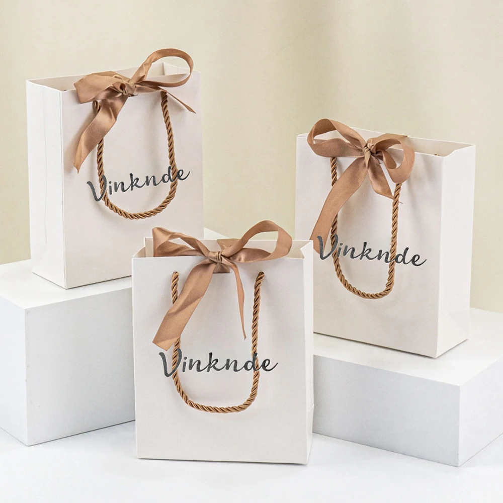

Custom Logo White Handheld Paper Gift Bags Bow Ribbon Reusable & Durable Bags Stylish Birthday Wedding Party Favors Package
