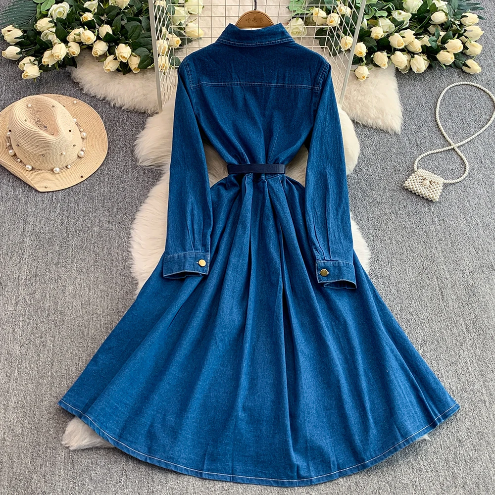 Sukienka damska dżinsowa w stylu retro, ciemnoniebieska, z klapami, bufiastymi rękawami, jednorzędowym zapięciem na metalowe guziki, kieszeniami, podkreślająca talię, z rozcięciem, sukienka koszulowa.