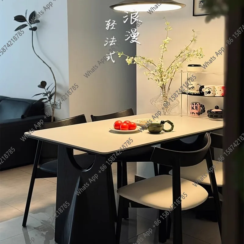 

AMedieval flying crow black solid wood dining table simple designer rectangular matte white rock slab dining table