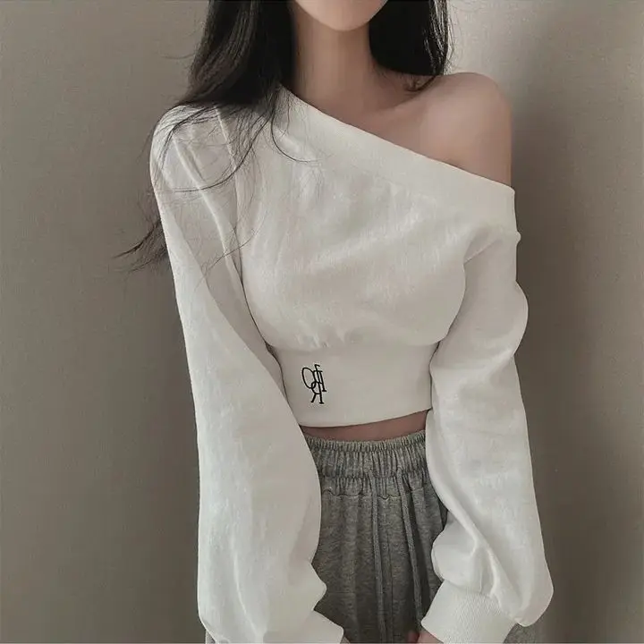 Long-sleeved sweater thin female spring niche personality irregular oblique collar off-the-shoulder waist slim Joker short.
