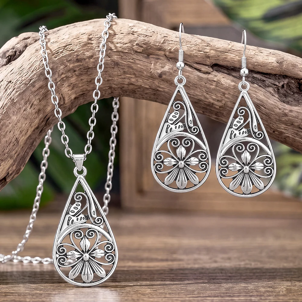 Bohemian-style cutout teardrop pendant necklace and earring set; vintage-style antique silver jewelry for women's daily wear.