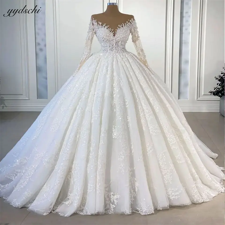 

Luxury Appliques Beading Pearls Crystal O-Neck Sweep Train Bling Wedding Dresses 2024 Illusion Full Sleeves BridalGowns