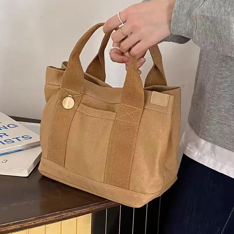 Nieuwe Japanse Tas 2024 Nieuwe Gelaagde Casual Canvas Tas Handheld Eenvoudige Instagram Stijl Lunchbox Bento Tas Handtas