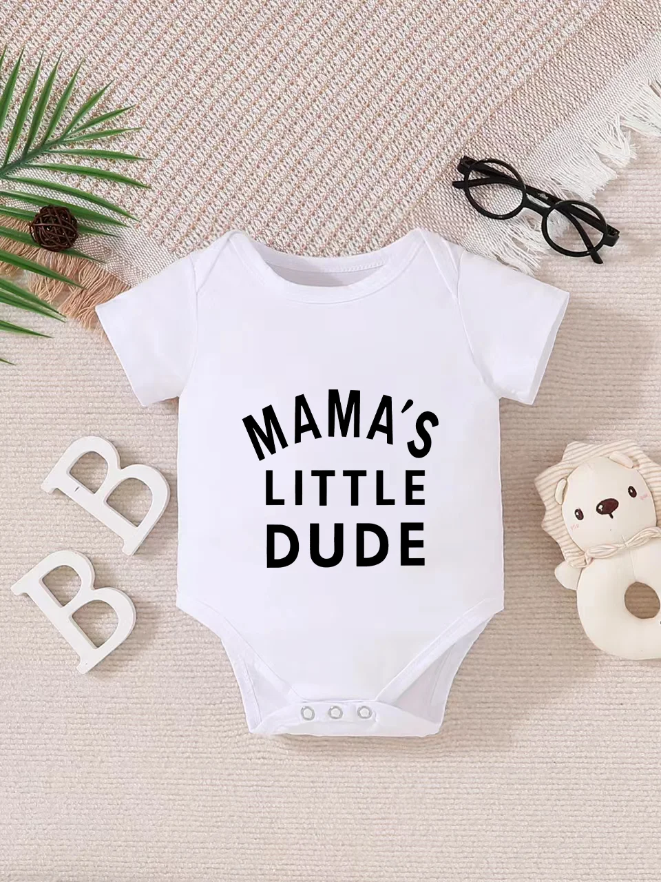 Playful letter-printed baby short-sleeve triangle bodysuit. Button closure for easy dressing, machine washable