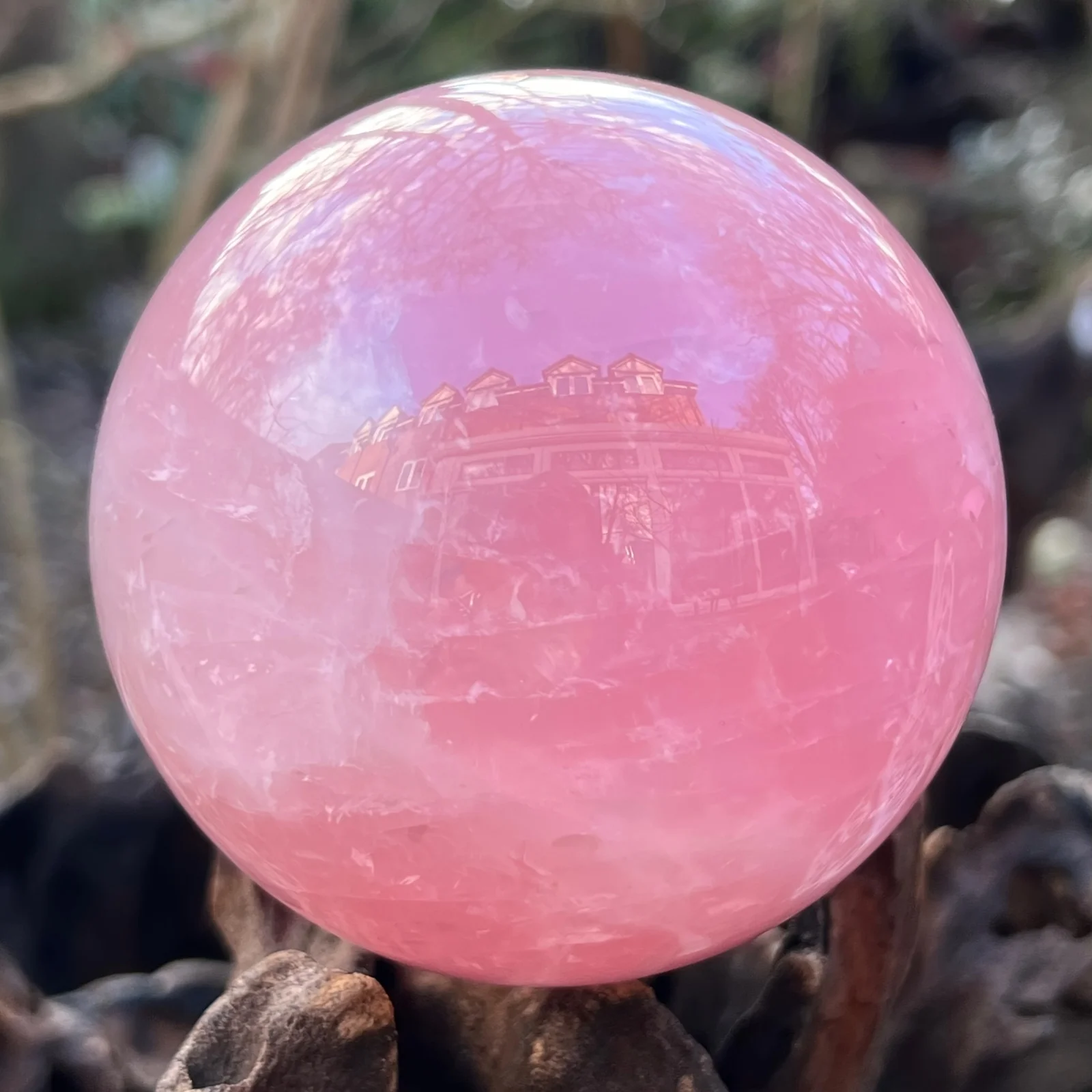 A large rose quartz crystal ball - a deep pink bohemian sphere, perfect for weddings and Valentine's Day decorations.
