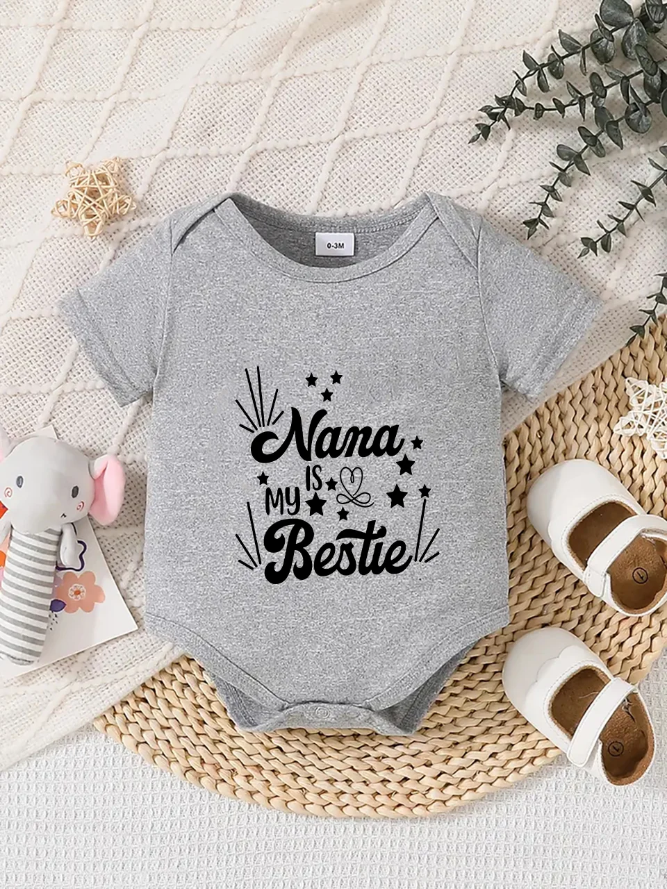 Playful letter-printed baby short-sleeve triangle bodysuit. Button closure for easy dressing