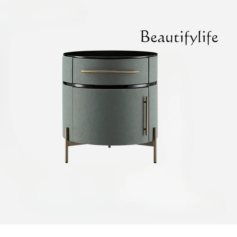 

Italian luxury leather bedside table bedroom home creative simple small table storage round stainless steel lockers.