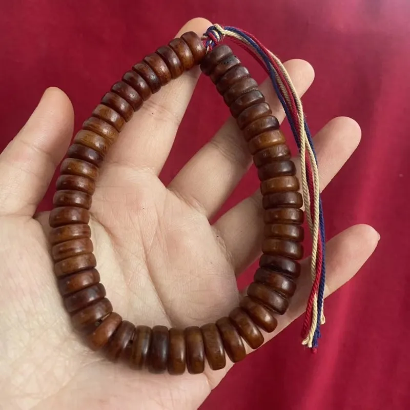 -style medicinal yak bone and hand-held string of prayer beads from the Tibetan region