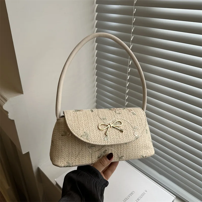 Korean version of fashionable versatile straw woven bag women's high-end bow thorn shoulder embroidered armpit bag