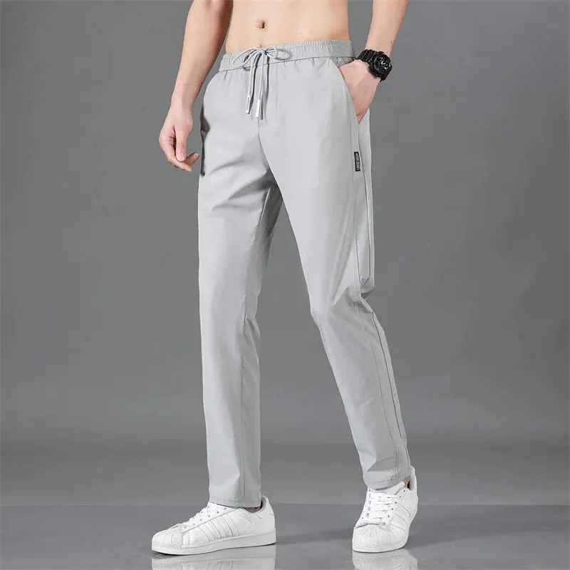 Pantalones casuales de negocios delgados de Color sólido, zapatillas de deporte de tubo recto, transpirables, elásticas para exteriores, dibujo de cintura, primavera y verano