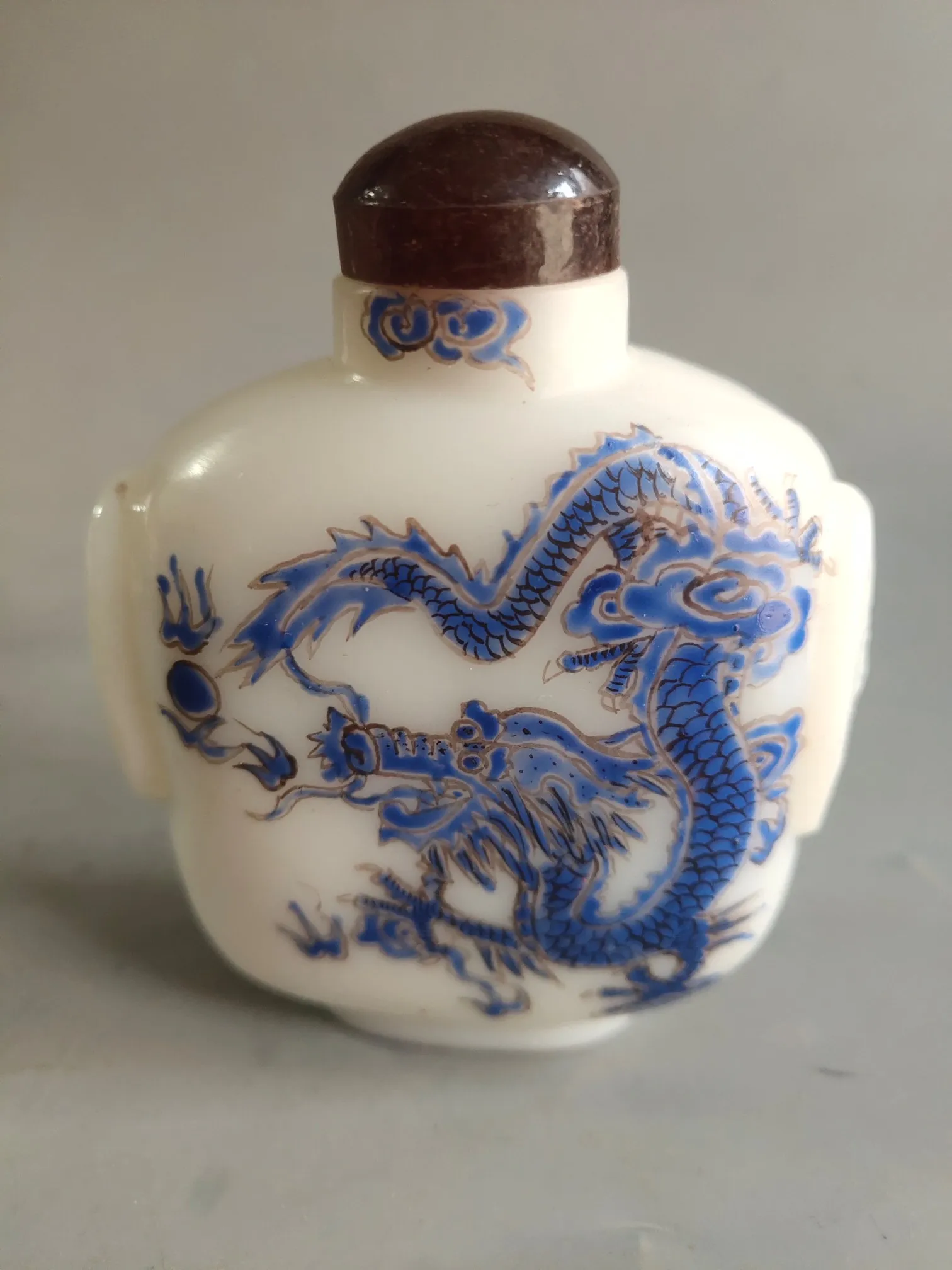 A selection of old Chinese colored glass bottles decorated with small ornaments