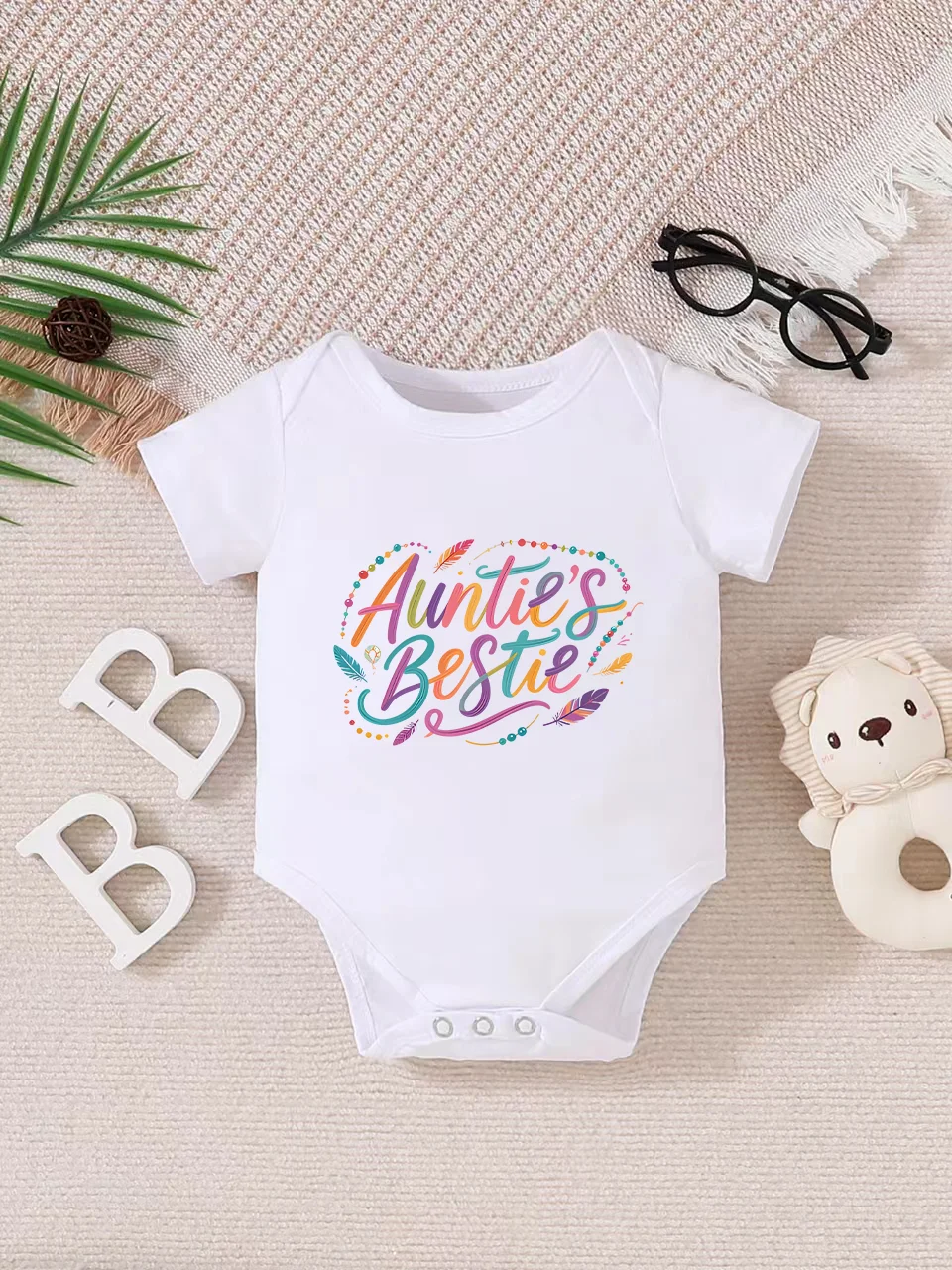 

Playful letter-printed baby short-sleeve triangle bodysuit. Button closure for easy dressing, machine washable