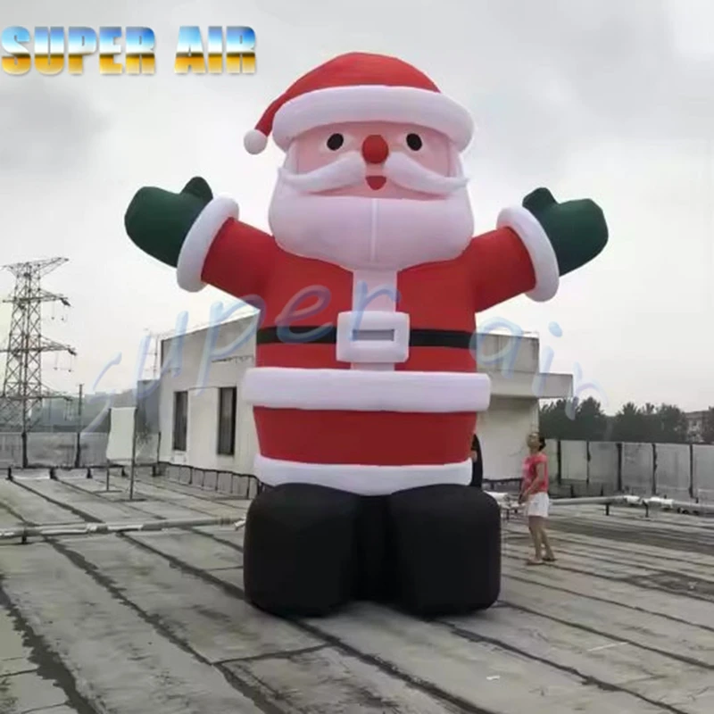 Decoración de celebración navideña al aire libre enorme inflable Santa Claus onda mano