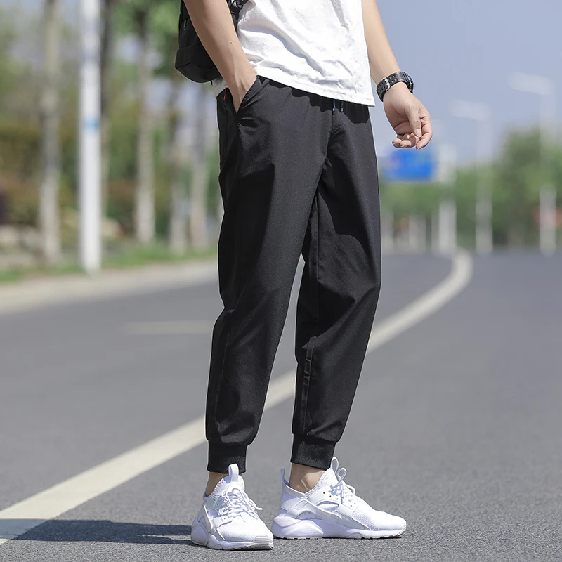 Wysokiej jakości nowa marka casualowe modne elastyczne spodnie dresowe z paskami, długie, ołówkowe, młodzieżowe, dopasowane, szybkoschnące spodnie męskie.