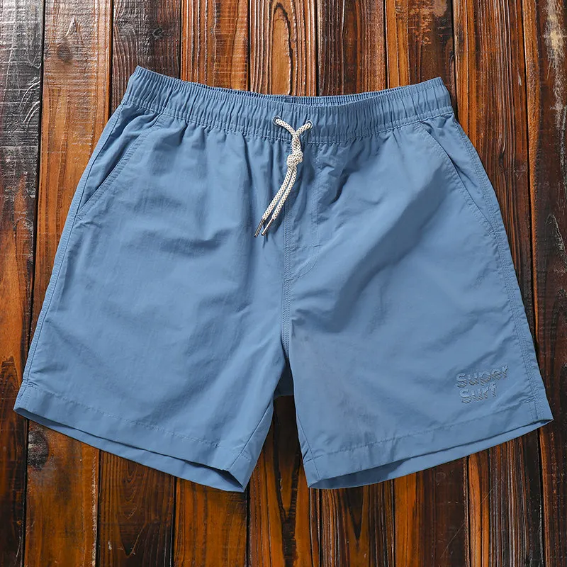 

Men's summer beach shorts, simple solid color, quick-drying, sports and casual wear, loose and breathable four-point shorts.
