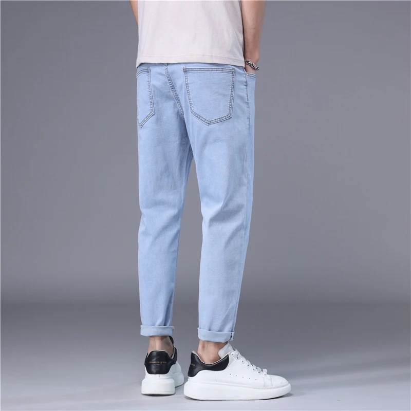 ฤดูร้อนกางเกงยีนส์ผู้ชายบางสไตล์เกาหลีสีฟ้าสีดําสีทึบยืดตรงสไตล์ SLIM FIT เท้า DENIM Cropped กางเกงชาย