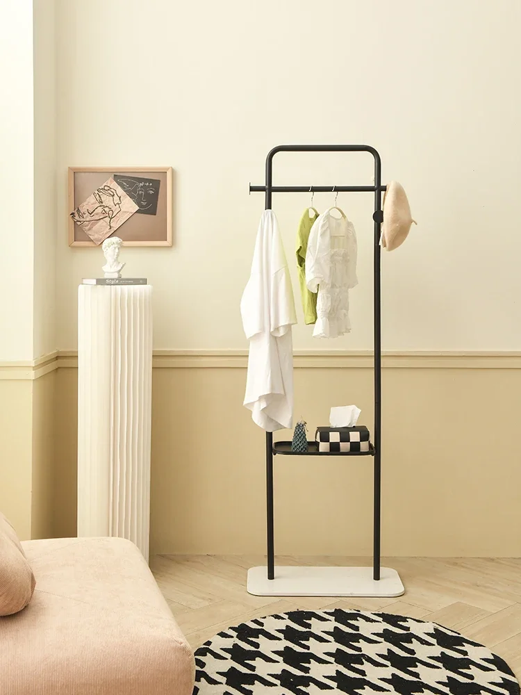 

A small household floor mounted clothes rack for hanging clothes. Room storage overnight clothes rack