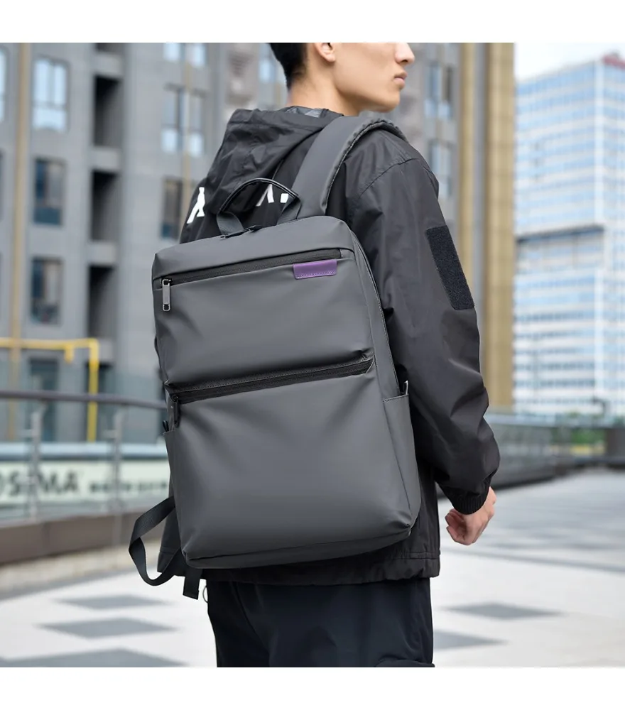 Black glossy waterproof backpack with small purple fabric label anti splash double front zipper compartments for casual daily