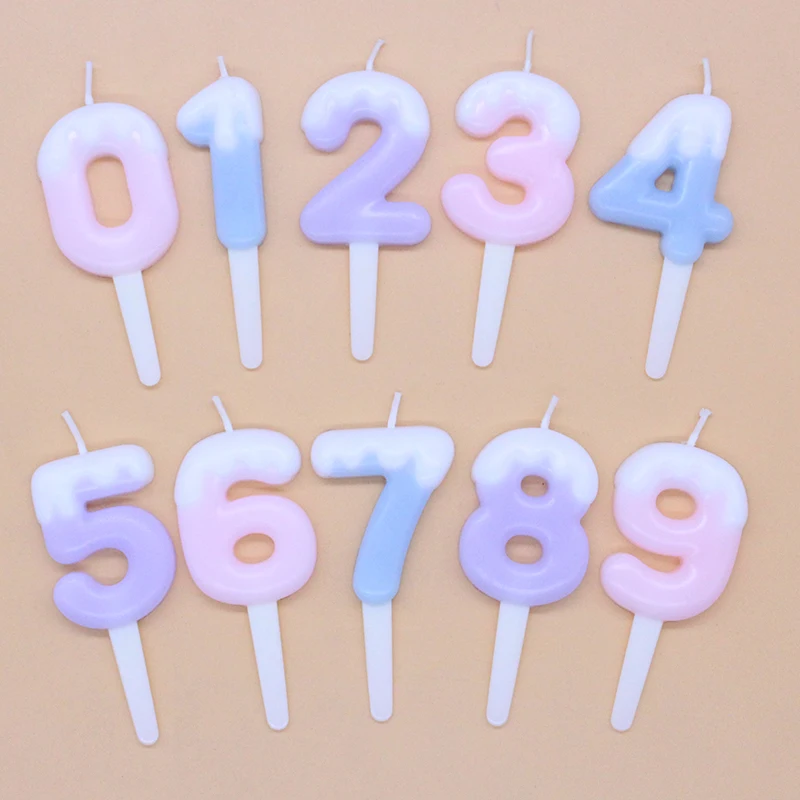 Baked cake decorated with cream, colorful candy color numbers 0-9, candle cartoon