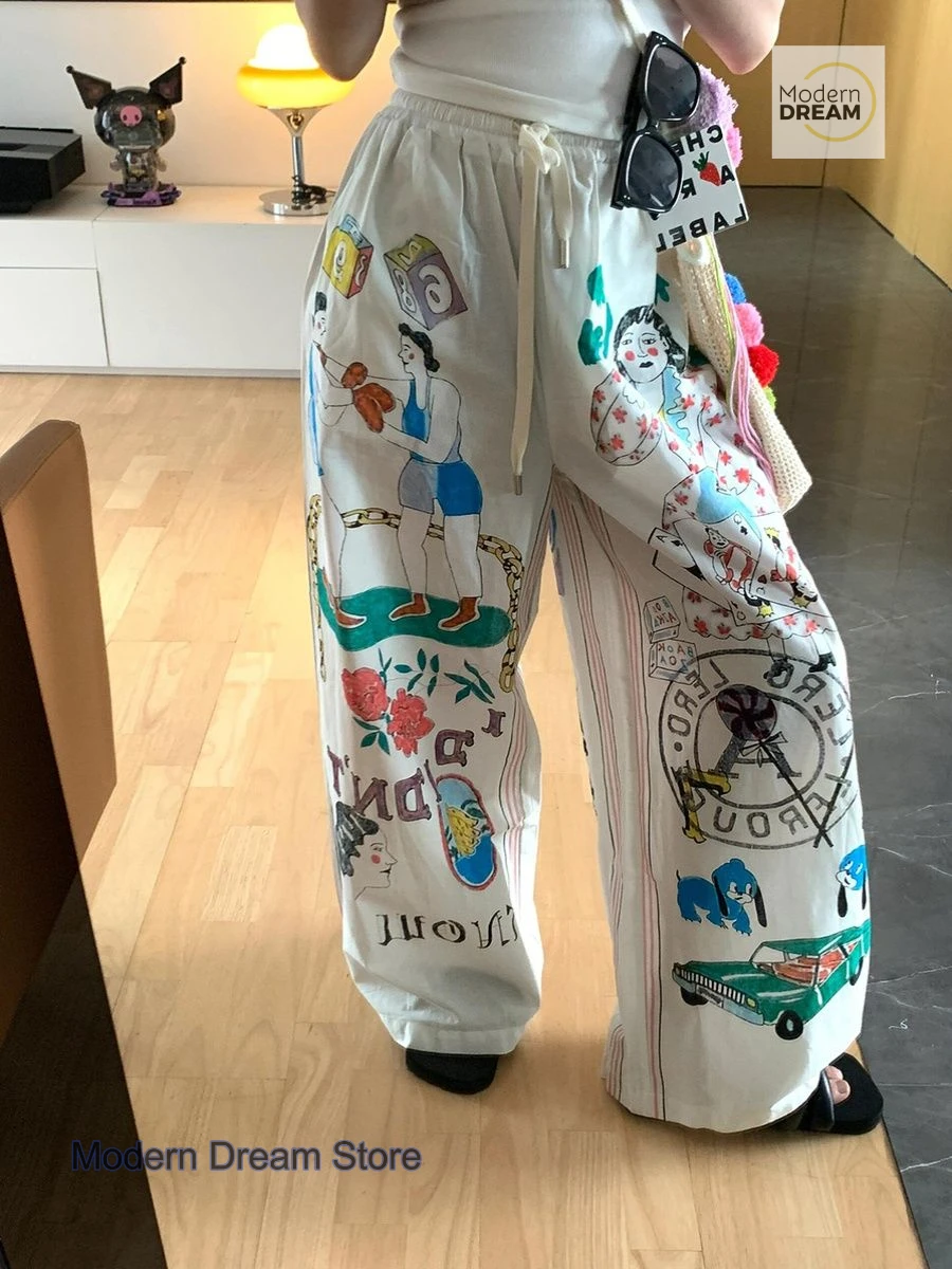 Korean version of simple minority cartoon graffiti printed pants women's summer new plus size design high waist casual pants.