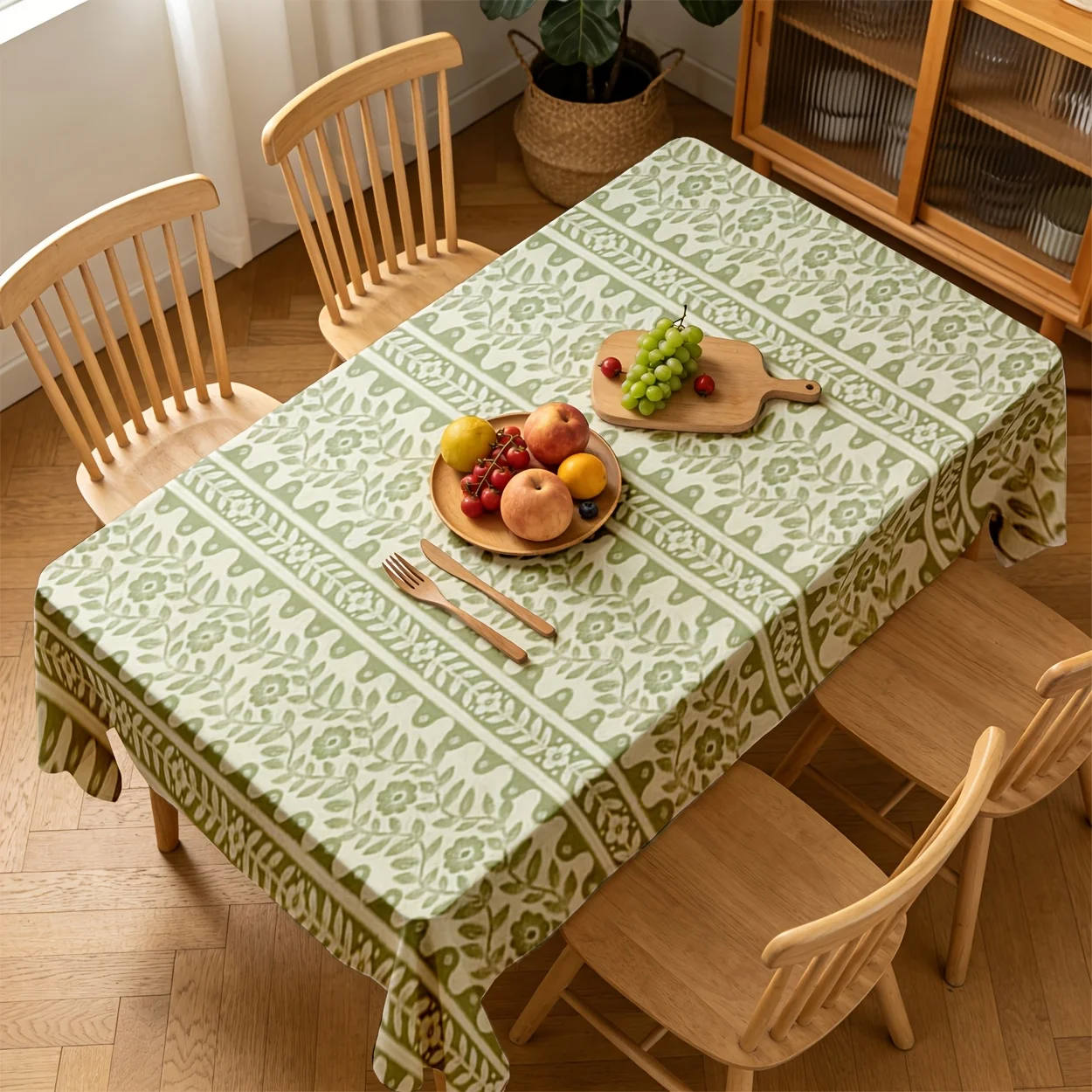 One rectangular vintage floral vertical stripe tablecloth in a light green color, made of durable polyester fabric.