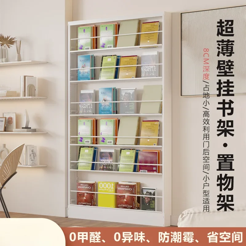 Steel books can be placed on the floor against the wall, picture books are wall-mounted behind the narrow door