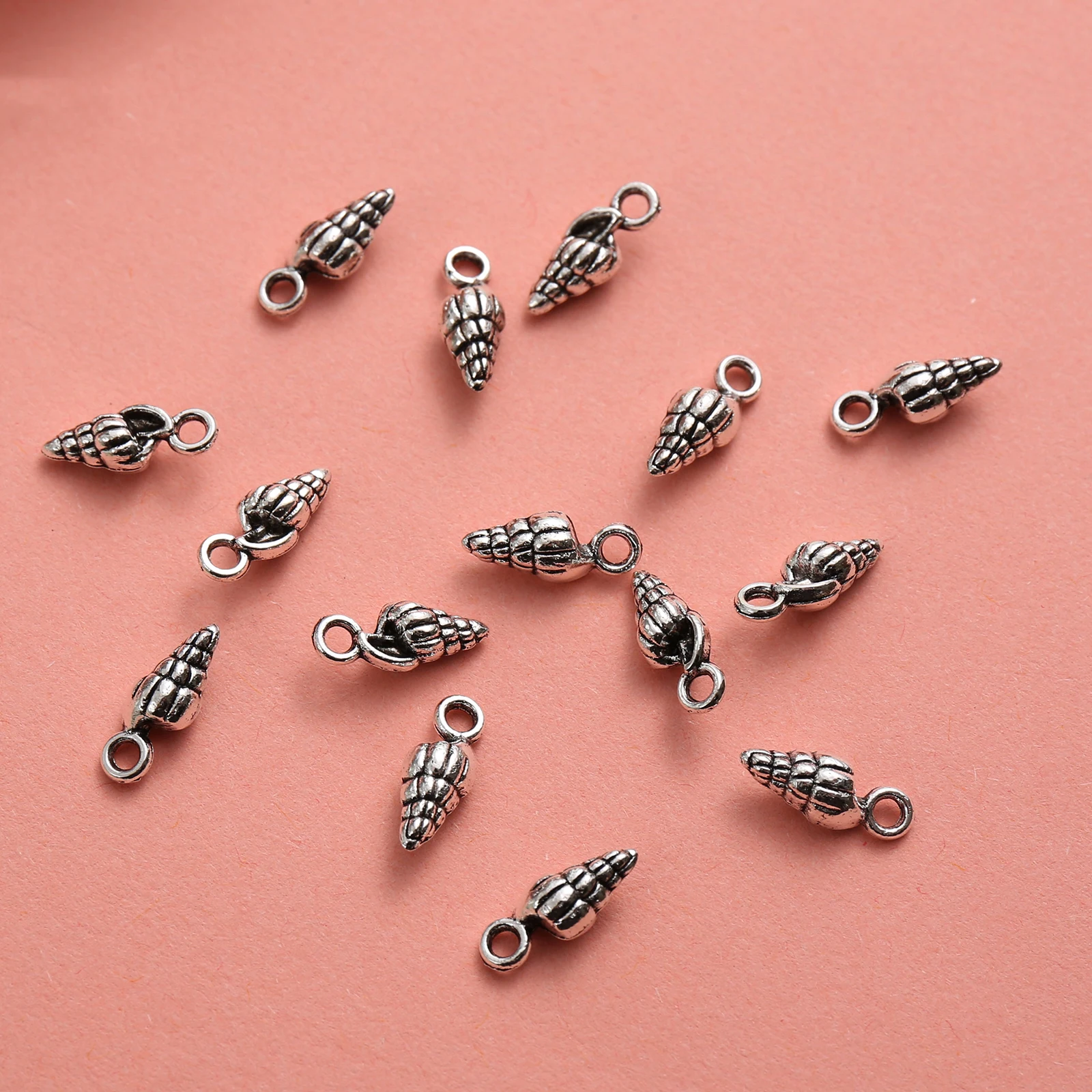 50 Mini Conch-Shaped DIY Handmade Pendants, with Spiral Texture That Replicates the Feel of Ocean Shells, Come with a Hanging Loop for Easy Attachment, Can Be Used to Make Bracelets, Necklaces, Key Pendants, and Seaside-Style Accessories Suitable for Summer Ocean-Themed Crafts view 3