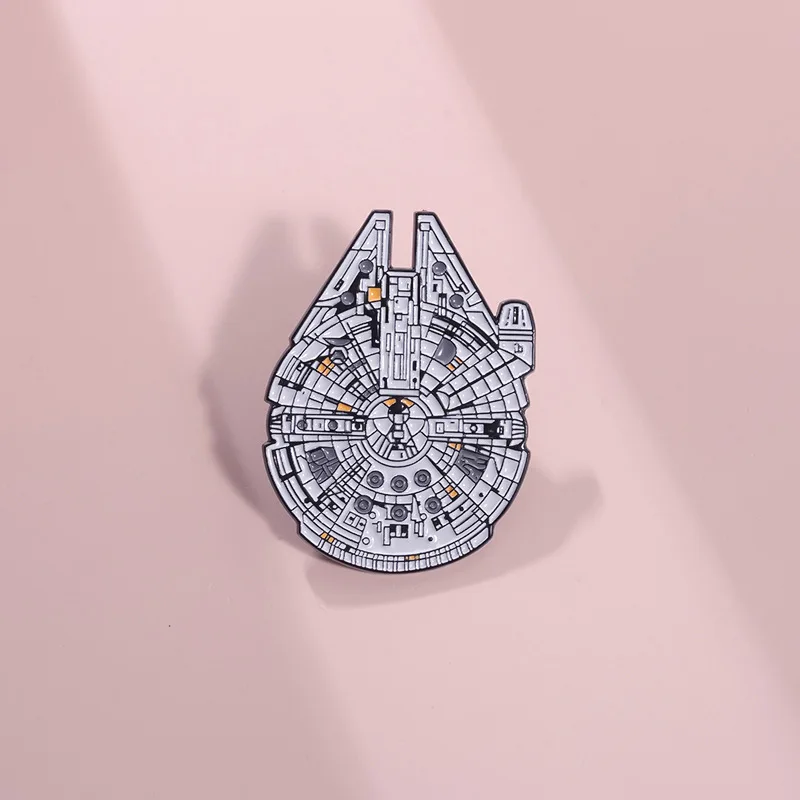 Surrounding Star Wars, the Millennium Falcon spacecraft features a brooch, personalized mechanical compass, and metal badge