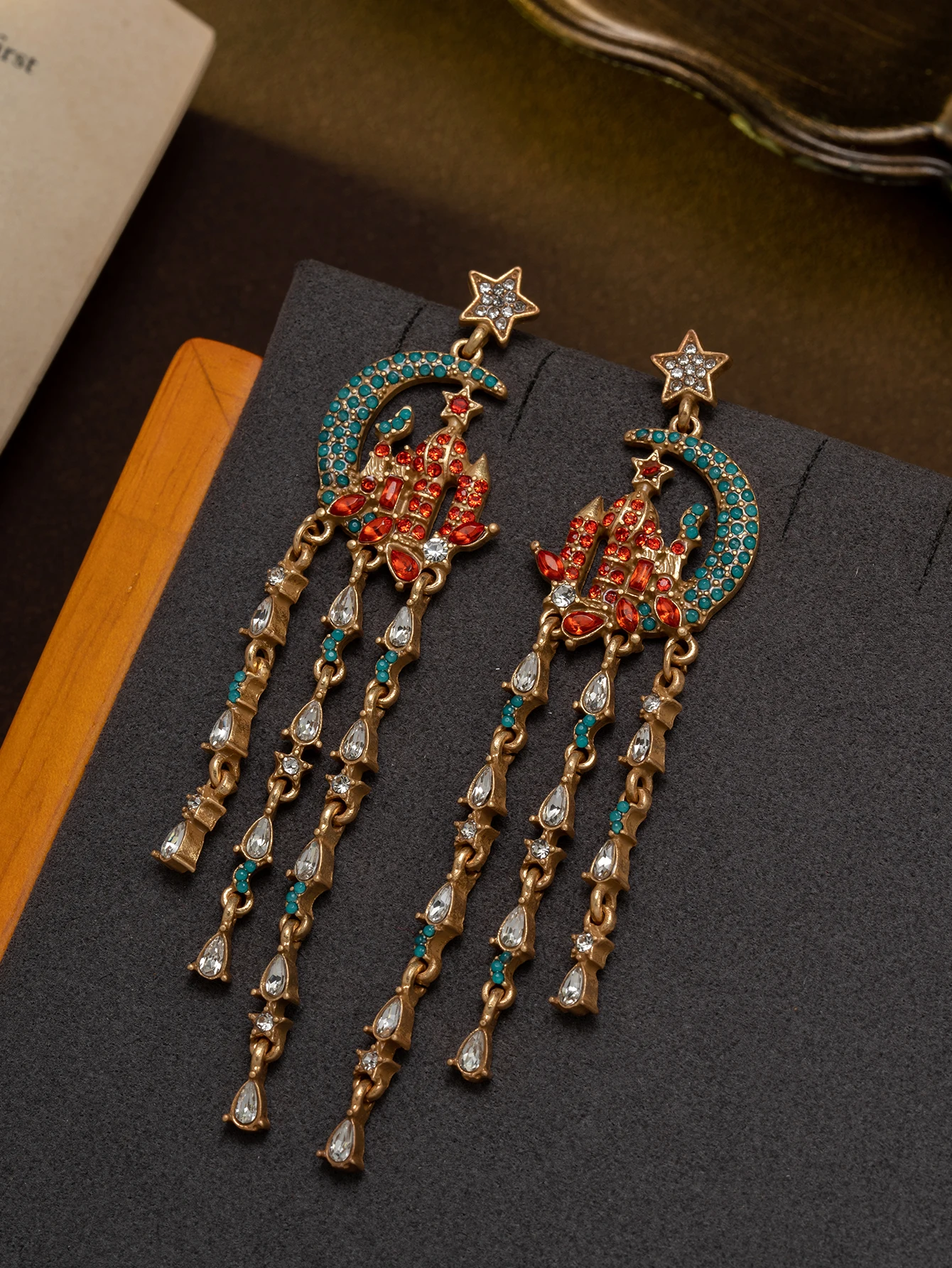 A pair of fashionable star and moon castle earrings with red and green diamond tassels, exotic palace-style party accessories, Halloween gift