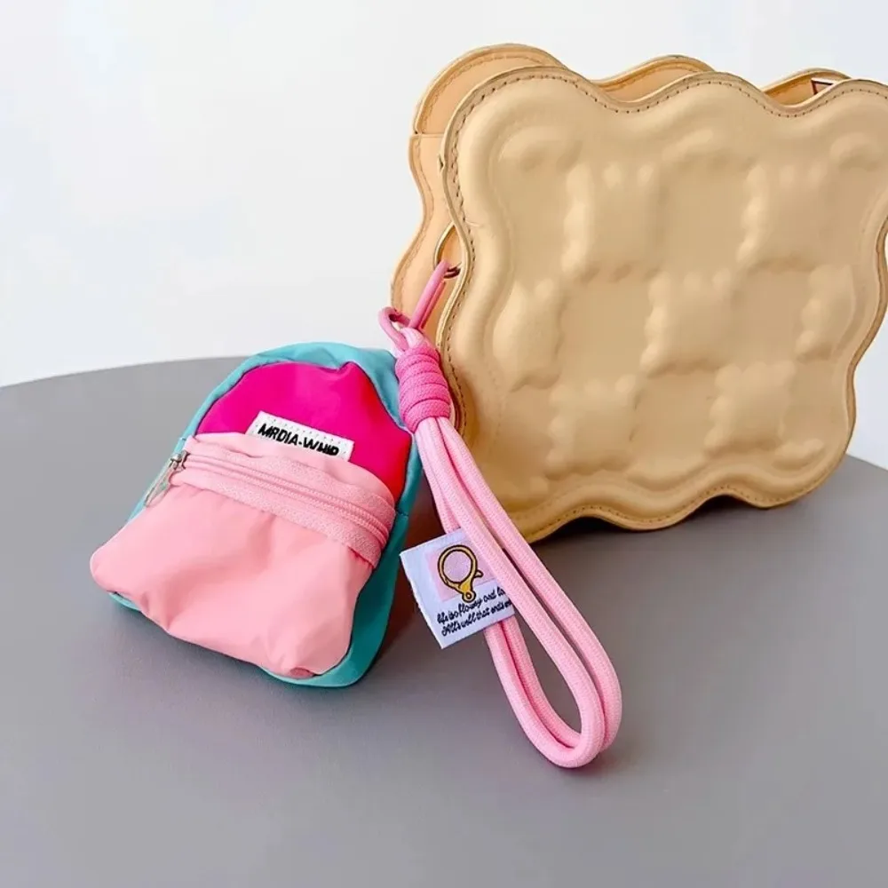 Monedero colgante creativo, correa de muñeca corta antirrobo, bolsa de almacenamiento para auriculares, colgante de Color contrastante, bolsa pequeña para llaves para niña