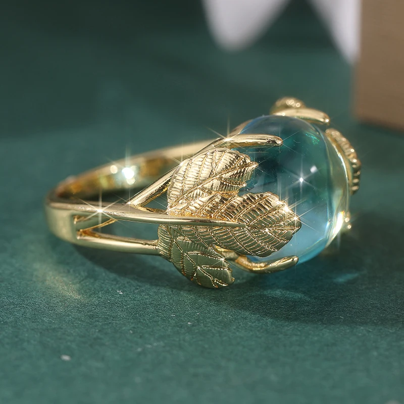 Vintage-Ring für Damen in Goldfarbe mit eingelegtem meerblauen Stein, Blatt- und geometrischer Schnitzerei, für den täglichen Gebrauch, Partyschmuck – Detail 4