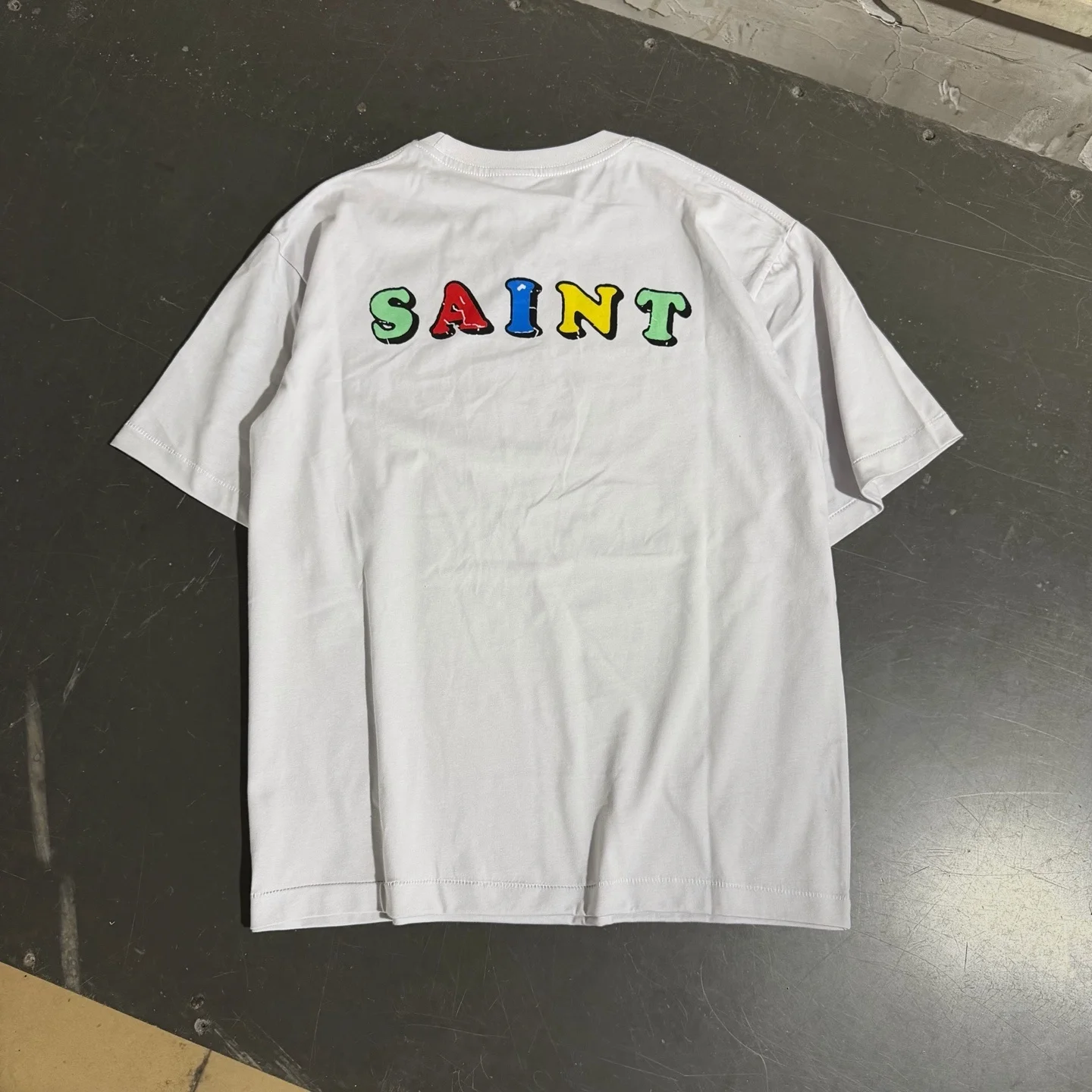 Saint The Front Features An Illustrated Story Slogan T Shirt Men Women High Quality 2026ss Tee Tops T-Shirt