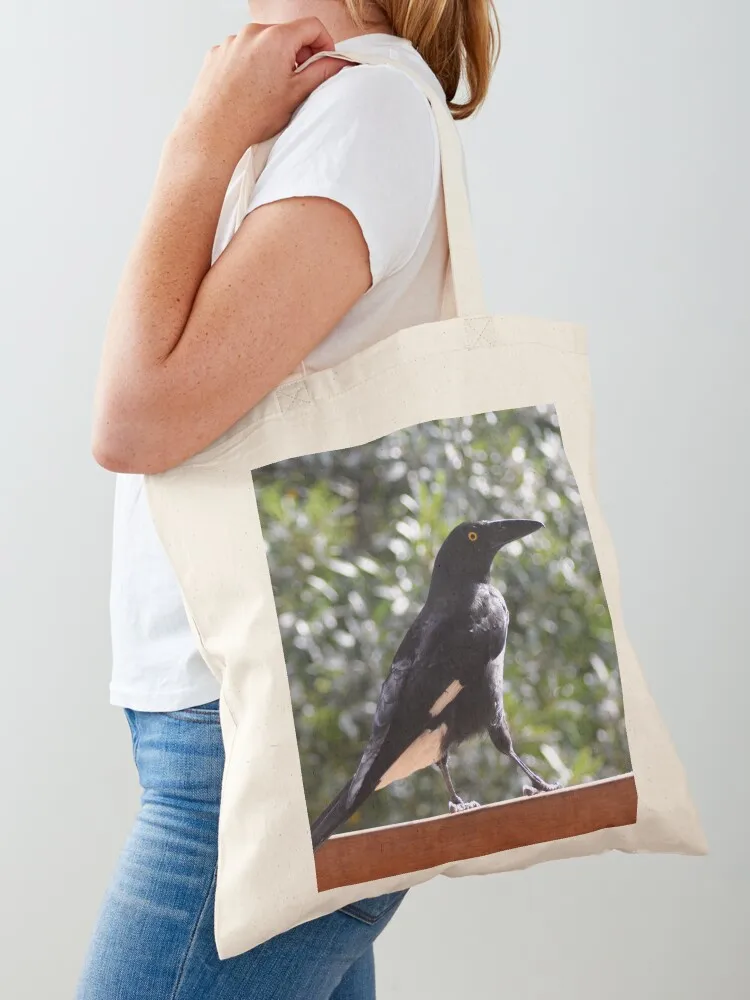 A currawong standing on a fence.A currawong standing on a fence. Tote Bag reusable shopping bag shopper bag woman